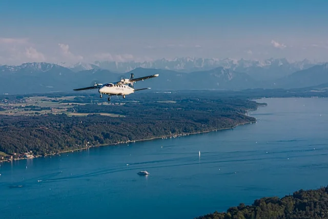Sightseeing Flight Prices in Bavaria with ALPEN AIR aircraft over lake and Alps