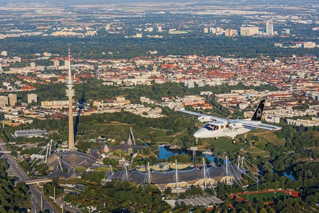 Munich with ALPEN AIR aircraft over Olympic Park and city panorama
