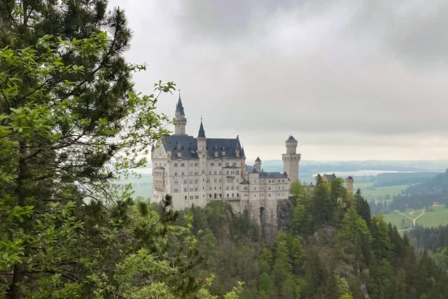 Neuschwanstein Castle view with forest and mountain scenery for a romantic proposal